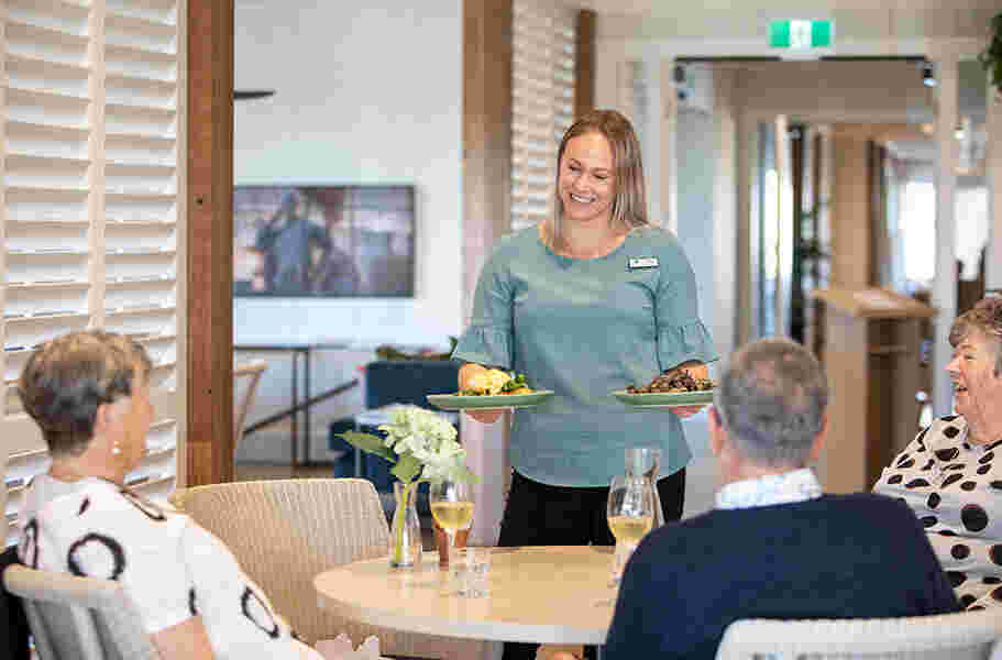 staff-bringing-food-to-customers-at-the-bloom-eatery-and-lounge